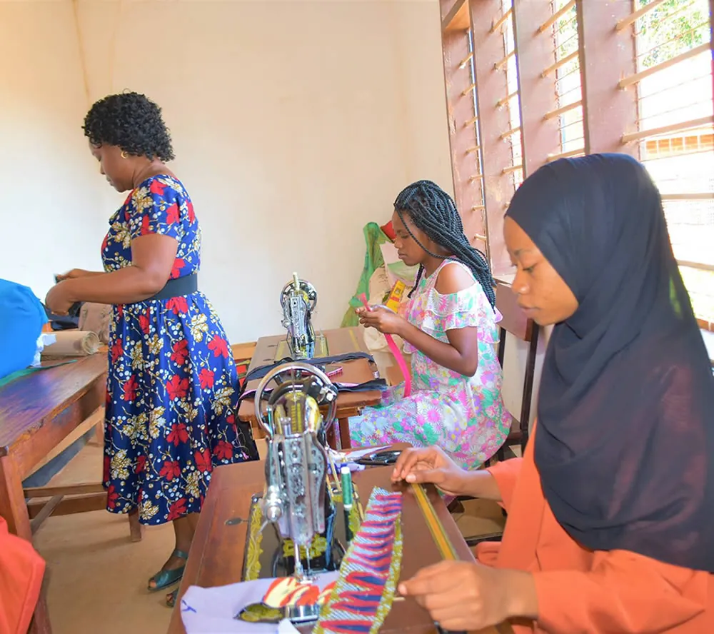 Women practising sewing skills in a SAWA training photograph